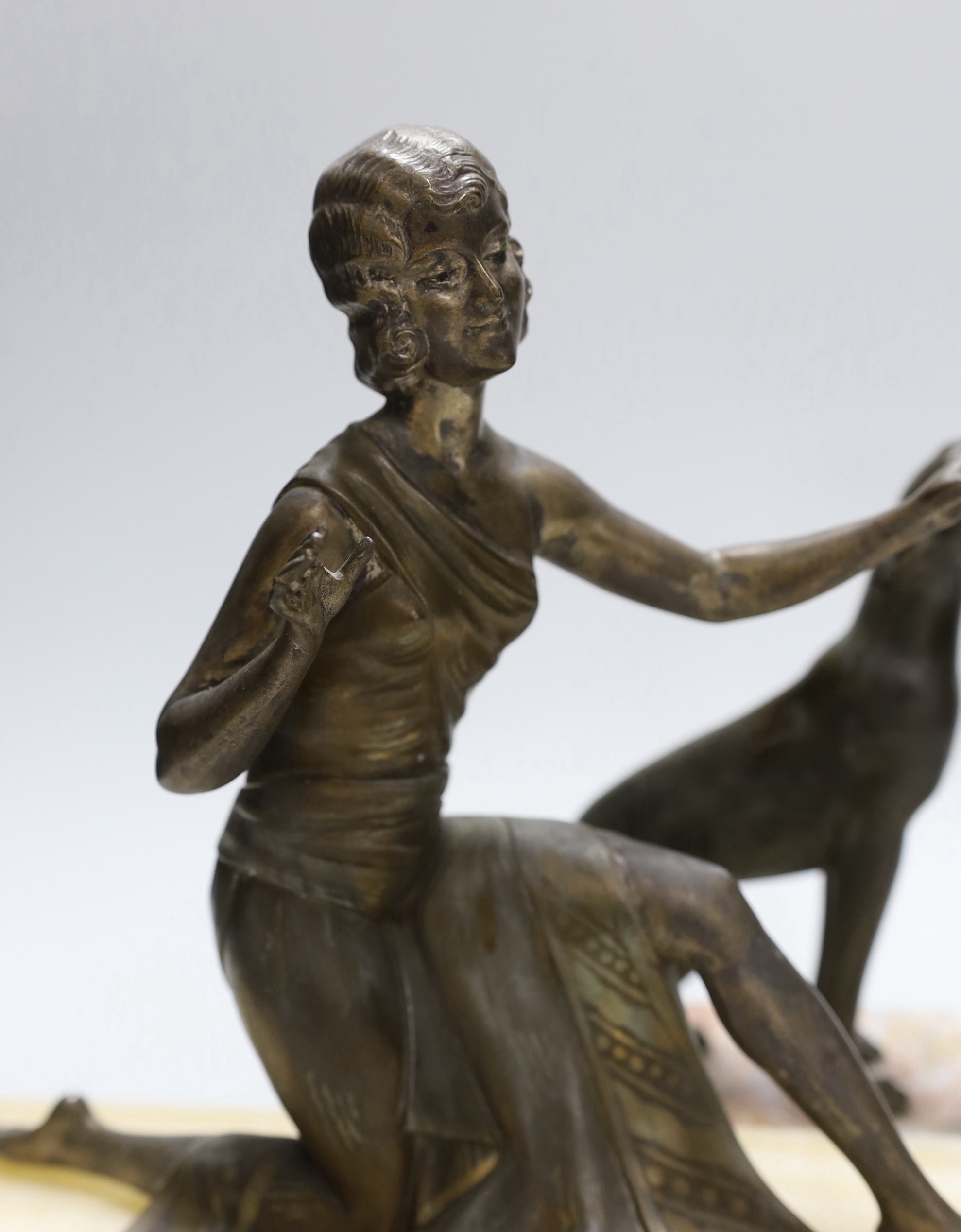 An Art Deco spelter figure of a girl and dog on marble base signed P.Sega, together with a similar Art deco figure of a female dancer on an onyx and red marble base, height 28cm